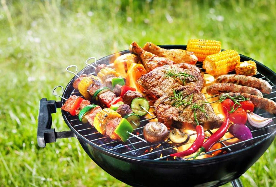 A griller with smoke placed outside in garden