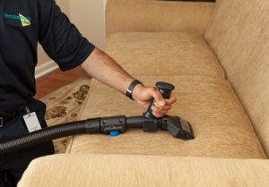 Technician cleaning a couch in Middlesex County