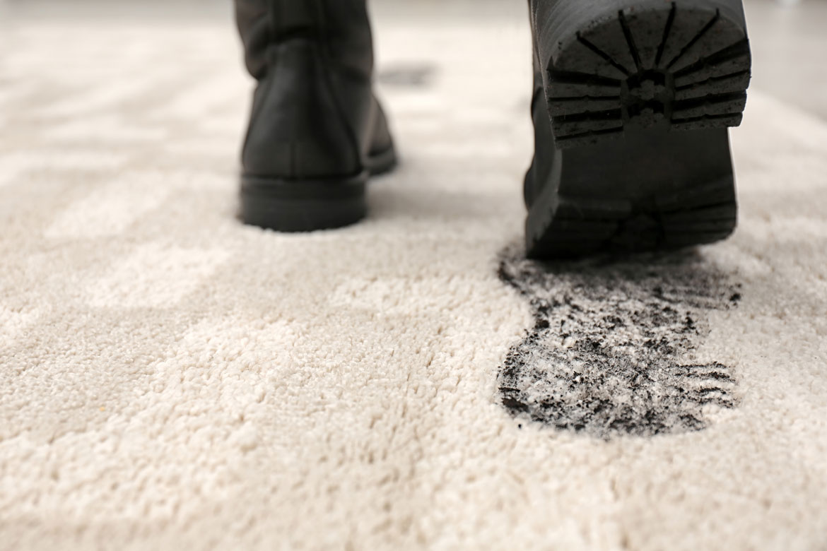 Person-leaving-muddy-footprints-on-carpet