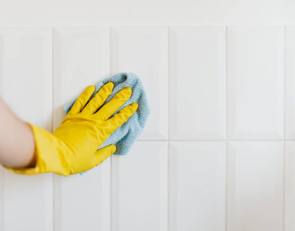 Person cleaning tile with cloth